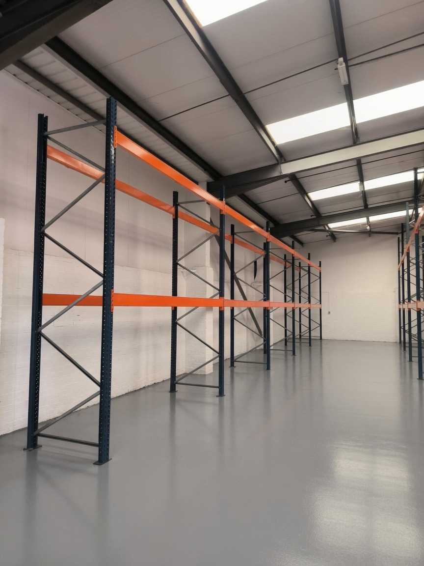 Warehouse Racking Installation UK - Long run of pallet racking against a painted wall | UM Storage Systems